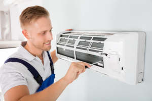 Technician installing air conditioning system